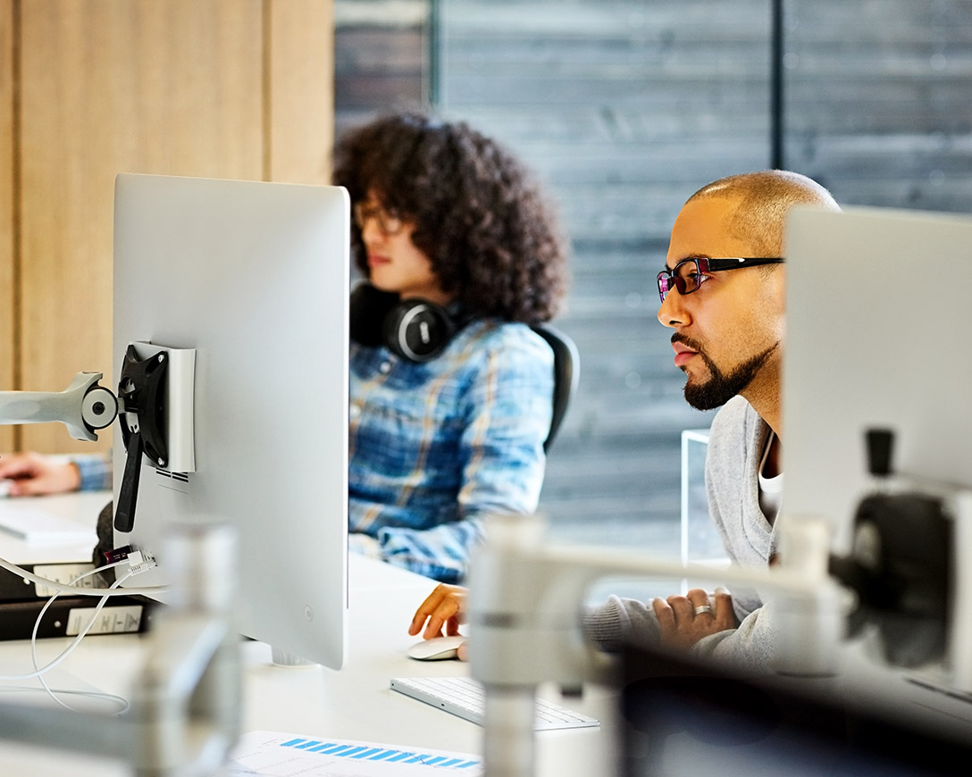 Recoverability - A man gives his full attention to a desktop monitor