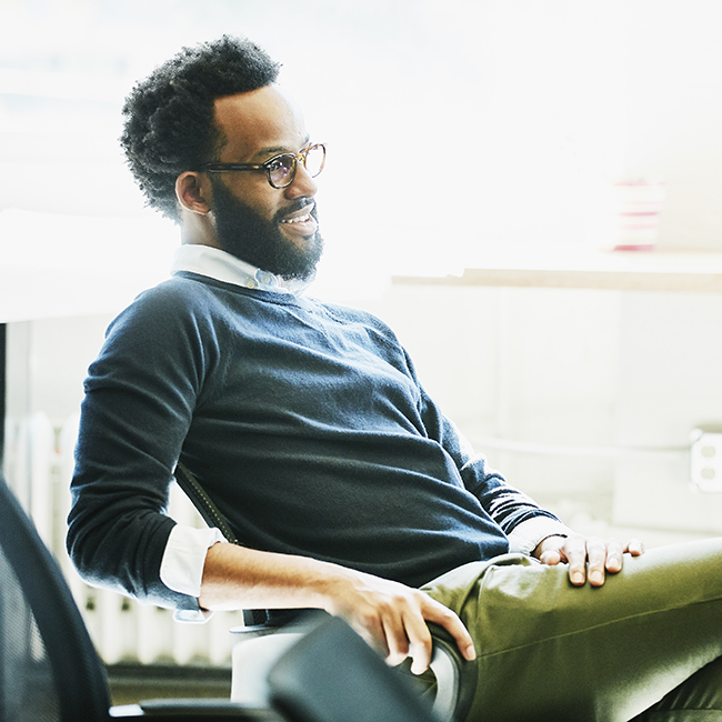 A professional man sitting relaxed in an office chair