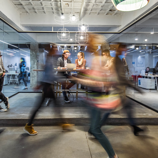 Office workers walking through building lobby.