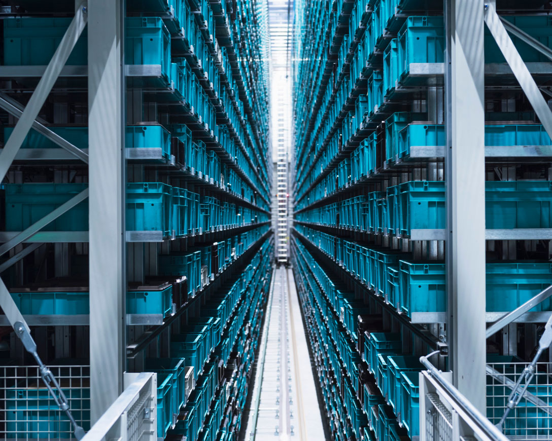 Rows of boxes in a long warehouse aisle.